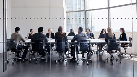 Executives gathered around a conference room table
